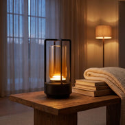 Morven Lantern cordless lamp lit on a side table beside a window in the evening