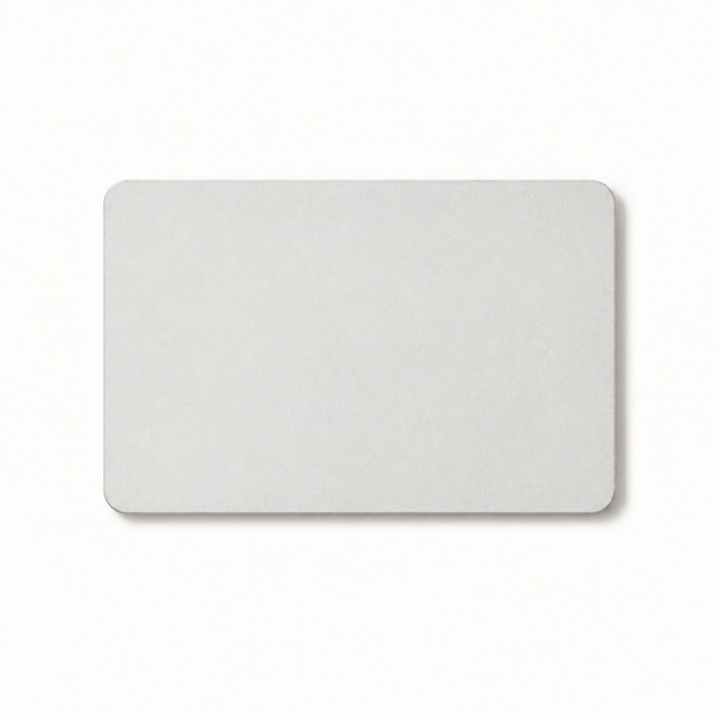 Morven Cairn diatomite stone bath mat in light grey, seen from above on a plain background
