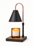 Morven Everglow candle warmer lamp in black, lit above a candle, on a plain background