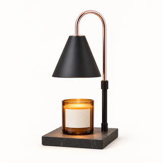 Morven Everglow candle warmer lamp in black, lit above a candle, on a plain background