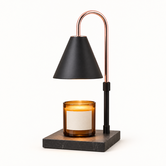 Morven Everglow candle warmer lamp in black, lit above a candle, on a plain background