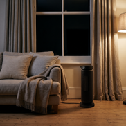 Morven Hearth space heater beside an armchair in a living room at night