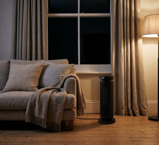 Morven Hearth space heater beside an armchair in a living room at night