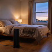 Morven Hearth space heater beside a bed in a bedroom at dusk