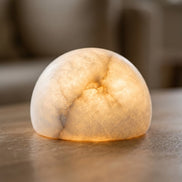 Close view of the Morven Opaline alabaster lamp glowing through the stone