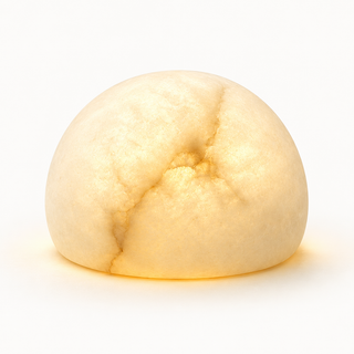 Morven Opaline alabaster table lamp, lit, on a plain background