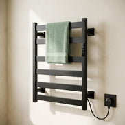 Morven Rail heated towel rail holding folded green towels in a bathroom