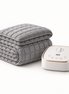 Morven Rest heated mattress pad in grey, folded with its controller, on a plain background