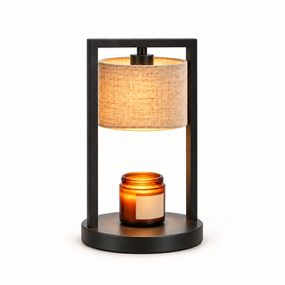 Morven Scrim candle warmer lamp with a cream linen shade, lit, on a plain background