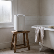 Morven Sprig compact dehumidifier on a wooden stool beside a bath