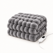 Morven Wrap heated throw in grey, folded with its controller, on a plain background